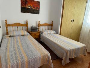 トレビエハにあるBella Antoniaのベッド2台が隣同士に設置された部屋です。
