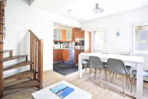 a kitchen and dining room with a white table and chairs at The Lighthouse - Maison, 800m à pied du centre in Barneville-Carteret