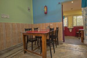 a dining room with a table and chairs at Collection O Dooars Dhaba And Restaurant in Hāsimāra