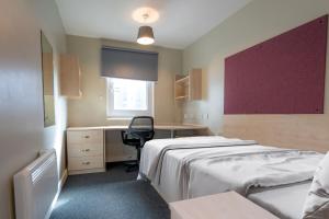 a hospital room with a bed and a desk at Ensuite Bedrooms with Shared Kitchen and Studios at The Heights in Birmingham in Birmingham