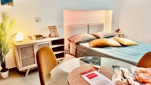a small room with two beds and a table at The Dream in Massa Lubrense