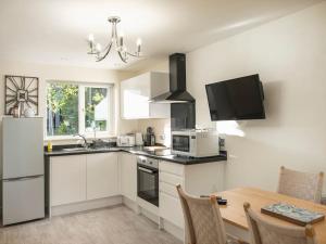 a kitchen with white cabinets and a table and a microwave at 35 Quaker Lane in Darlington