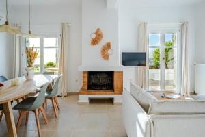 a living room with a table and a fireplace at Azula Luxury Apartments in Parikia