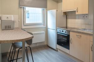 a kitchen with a white refrigerator and a counter at Ensuite Bedrooms with Shared Kitchen and Studios at The Heights in Birmingham in Birmingham