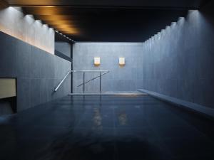 une piscine vide avec deux lumières sur le mur dans l'établissement SOKI ATAMI, à Atami