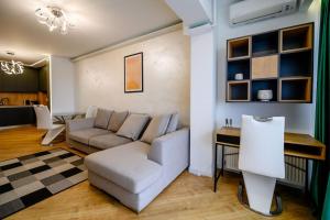 a living room with a couch and a table at Northern Horizon in Voluntari