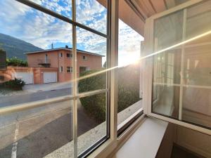 a window with a view of a house at Ferienwohnung Romantica in Felsberg