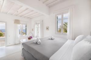 Rúm í herbergi á Fos Apartments Mykonos