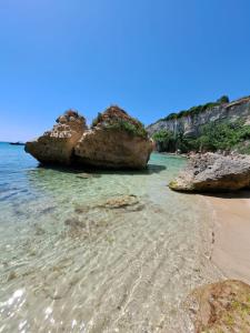 a beach with two large rocks in the water at B&B Ancora del Sud in Otranto