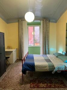a bedroom with a bed and a window at Green House in Genoa