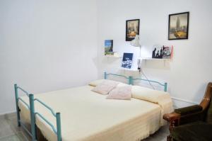a bedroom with a bed and a chair at One bedroom apartement with city view at Loceri in Loceri