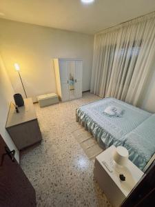 a bedroom with a blue bed and a window at CASA VACANZE DA LUCA in SantʼElpidio a Mare