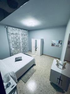 a bedroom with a bed and a table and a refrigerator at CASA VACANZE DA LUCA in SantʼElpidio a Mare +12 photos