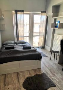 a bedroom with a bed and a large window at TOM ROOM - Cracow City Centre in Krakow