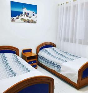 En eller flere senge i et værelse på 2 bedrooms apartement at Fnideq 10 m away from the beach with furnished garden