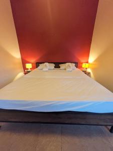 a large bed in a room with two lamps at Goodtime Utopia Guesthouse in Koh Tao