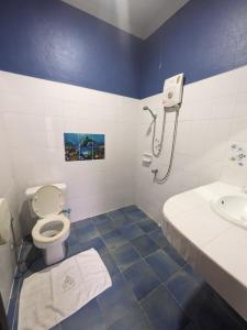 a bathroom with a toilet and a sink at Goodtime Utopia Guesthouse in Koh Tao