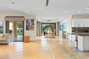 a kitchen and living room with a couch and a table at Luxury Villa Robledal By Mabiente - Views of the sea and the golf course in Marbella