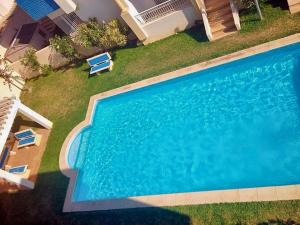 an overhead view of a swimming pool with two lawn chairs at 2 bedrooms apartement at Hammamet 100 m away from the beach with sea view shared pool and balcony in Hammamet