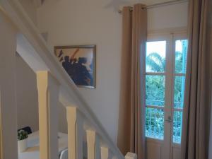 a staircase with a glass door and a window at Vivi's Apartments Loft in Spetses +11 photos