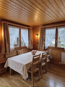 a dining room with a table and some windows at Taubenhaus OG in Fiesch