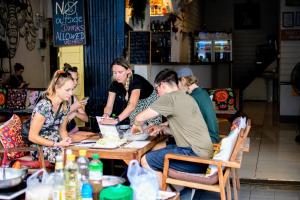 a group of people sitting around a table at Back Home Backpackers Hostel in Bangkok +88 photos