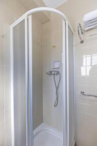 a shower with a glass door in a bathroom at Itaca Colón by Soho Boutique in Córdoba