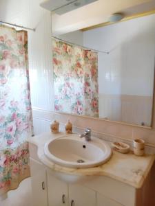 a bathroom with a sink and a mirror at 2 bedrooms apartement with enclosed garden and wifi at Urqueira in Urqueira