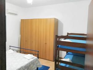 a bedroom with a bunk bed and a ladder to a bunk bed at One bedroom apartement at Mazara del Vallo 500 m away from the beach with enclosed garden in Mazara del Vallo