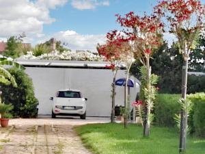 a white car parked in a parking lot at One bedroom apartement at Mazara del Vallo 500 m away from the beach with enclosed garden in Mazara del Vallo