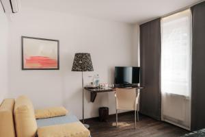 TV a/nebo společenská místnost v ubytování Helvetia Rooms + 7 fotografií