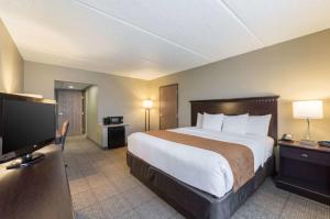a hotel room with a bed and a flat screen tv at Comfort Inn & Suites ATX North in Austin