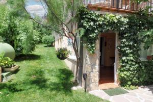 a house with a yard with green grass at One bedroom apartement with furnished garden and wifi at Collado Villalba in Collado-Villalba