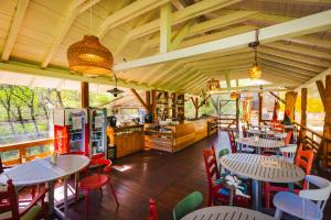 a restaurant with tables and chairs in a room at Alunis RETREAT in Aluniş