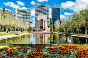 a fountain in a park with buildings in the background at TWO BEDROOM Apartment in Sydney