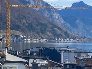 a view of a body of water with a crane at CityLake G23 Apartments in Gmunden