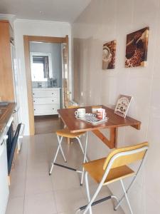 a kitchen with a wooden table and chairs in a room at 2 bedrooms apartement with shared pool and terrace at Ciruena in Cirueña