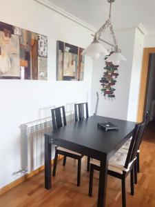a black dining room table and chairs in a room at 2 bedrooms apartement with shared pool and terrace at Ciruena in Cirueña