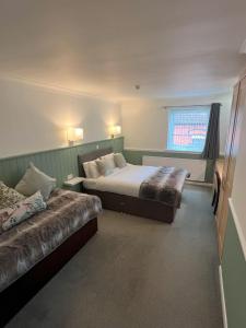 Postel nebo postele na pokoji v ubytování Millfields Hotel