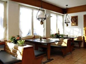 a large room with a table and some windows at Hotel zum Roten Löwen in Hildisrieden