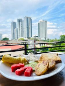 een bord met groenten en brood op tafel bij Regent Residencies - Colombo in Colombo