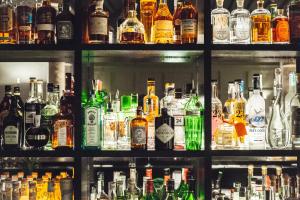 a bar filled with lots of bottles of alcohol at Sant Francesc Hotel Singular in Palma de Mallorca
