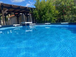 a swimming pool with two chairs and a swing at Sea House Bol in Bol