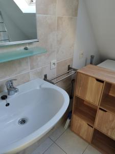 a bathroom with a white sink and a mirror at Holiday Home Nieuwendamme in Nieuwpoort