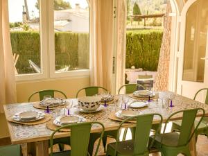 a table in a room with a table and chairs at LA VILLA MEDITERRANEA DE HERACLES en Denia in Denia