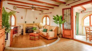 a living room with a couch and a table at LA VILLA MEDITERRANEA DE HERACLES en Denia in Denia