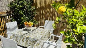 a table and chairs with a bowl of fruit on it at The Dream in Massa Lubrense