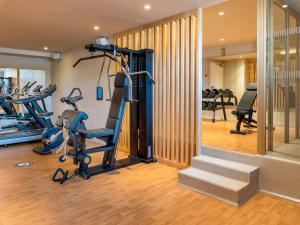 a gym with treadmills and ellipticals in a room at Novotel Madrid City Las Ventas in Madrid