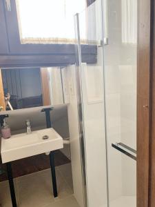 a bathroom with a sink and a glass shower at One bedroom apartement with city view furnished terrace and wifi at Granada in Granada
