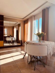a living room with a table with a vase of flowers on it at Chez Nata in Rouen